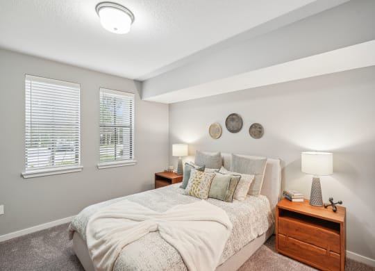 the master bedroom has plenty of windows and a comfy bed at Edge75, Naples, Florida 34104