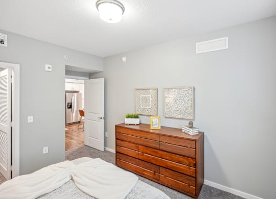 a bedroom with a dresser and a bed at Edge75, Naples, Florida 34104