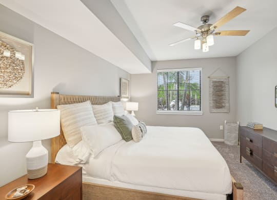a bedroom with a large bed and a ceiling fan at Edge75, Naples, Florida 34104