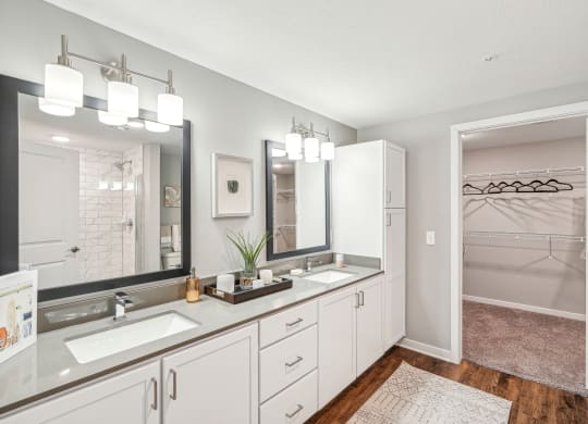 a white bathroom with two sinks and a mirror at Edge75, Naples, Florida 34104