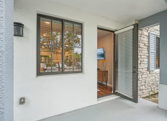 the entrance to a home with a large window and a patio at Edge75, Naples, Florida 34104