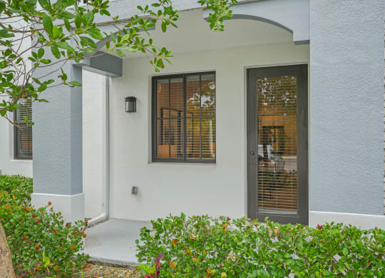 the front entrance of a house with a door and windows at Edge75, Naples, Florida 34104