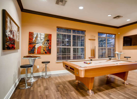 a game room with a pool table and a tv at Heritage at Stone Mountain, Northglenn, CO, 80233