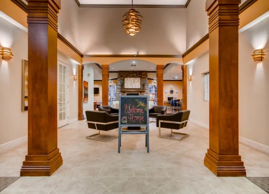 Lobby with a chalkboard sign in the middle at Heritage at Stone Mountain, Northglenn, CO, 80233