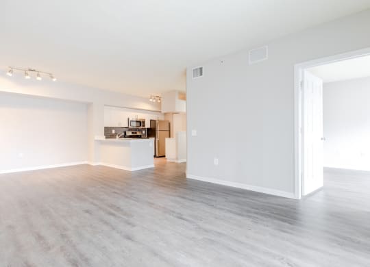 an empty living room with a kitchen in the background at Heritage Bay, Jensen Beach, FL 34957
