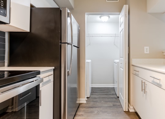 a kitchen with white cabinets and stainless steel appliances at Heritage Bay, Jensen Beach, FL 34957