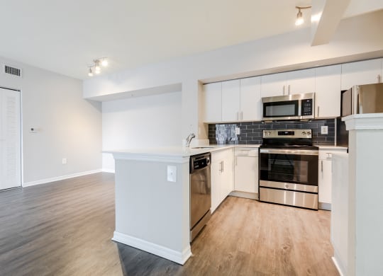 a kitchen with white cabinetry and stainless steel appliances at Heritage Bay, Jensen Beach Florida