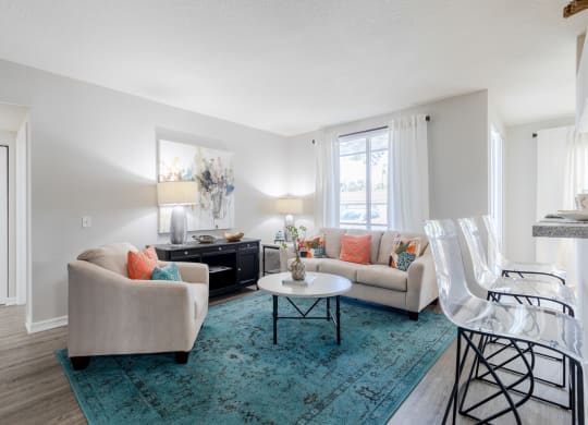 a living room with white walls and a turquoise rug at Heritage Bay, Florida, 34957