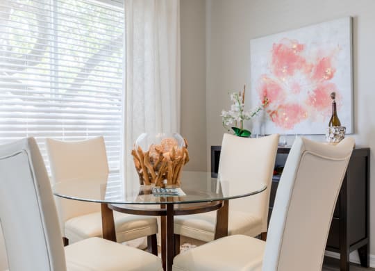 a dining room with a glass table and white chairs at Heritage Bay, Florida, 34957
