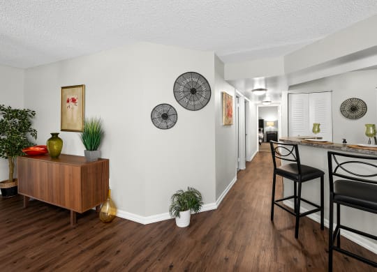 a living room with a bar and a kitchen with a dining room table and chairs at Pembroke Pines Landings, Pembroke Pines