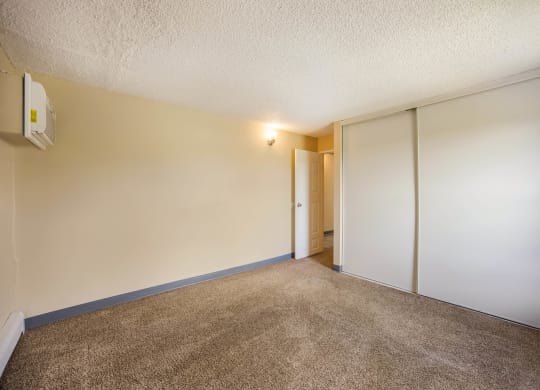 a bedroom with white walls and a carpeted floor at Broadmoor Springs, Colorado Springs, CO, 80906