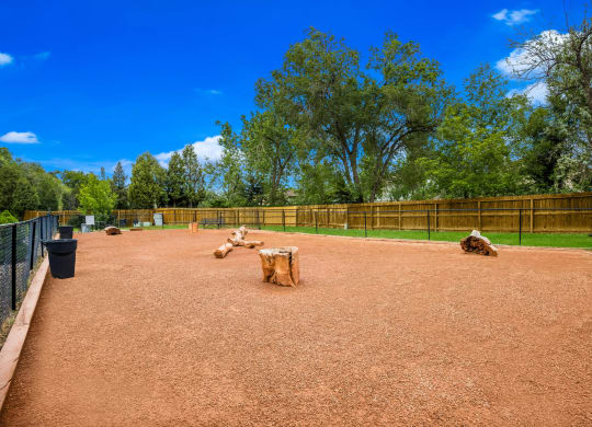 a dog park with trees and a blue sky in the background at Broadmoor Springs, Colorado Springs, CO, 80906