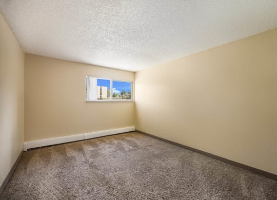 an empty bedroom with a small window at Broadmoor Springs, Colorado Springs, CO, 80906