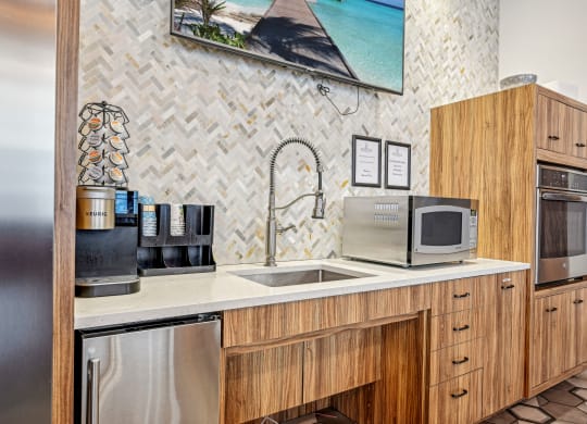 a kitchen with a sink and a microwave at Riverwalk Apartments, Lawrence, MA