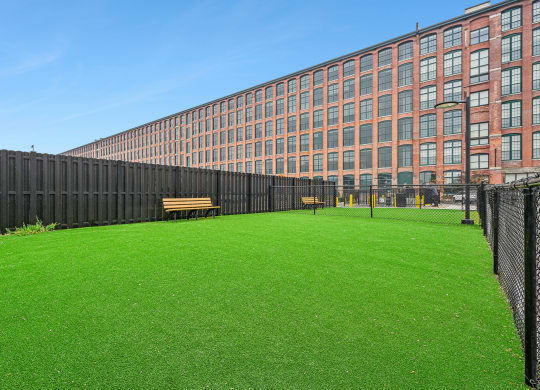 a green lawn in front of a large building at Riverwalk Apartments, Lawrence, MA