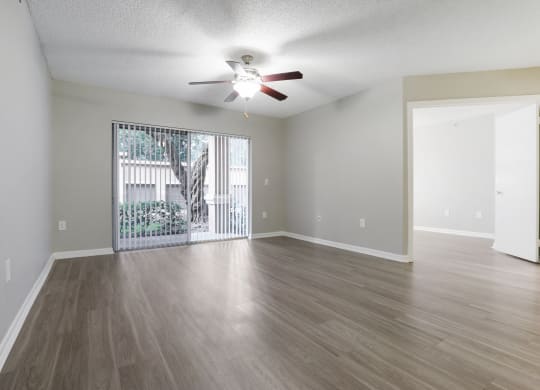 an empty living room with a ceiling fan and a window at Pembroke Pines Landings, Florida