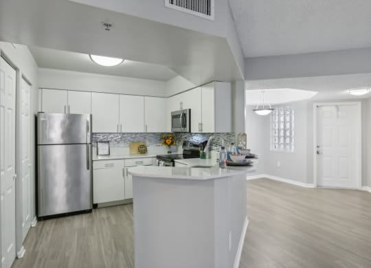 a kitchen with white cabinets and a stainless steel refrigerator at Pembroke Pines Landings, Florida, 33025