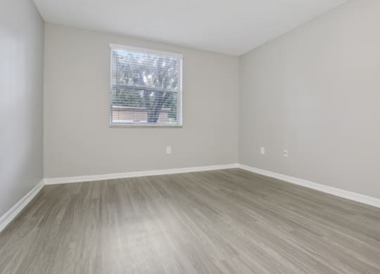 an empty room with wood floors and a window at Pembroke Pines Landings, Florida