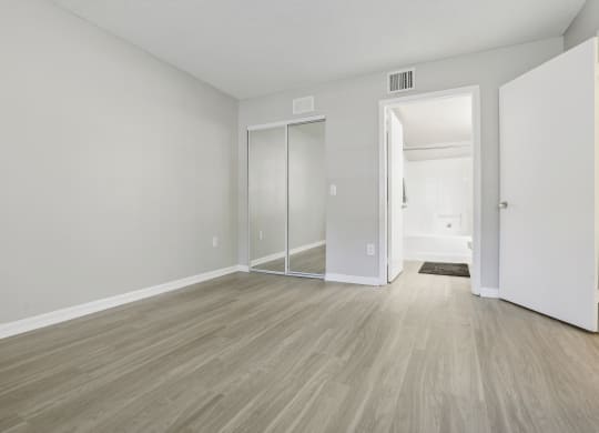 an empty living room with white walls and wood flooring at Pembroke Pines Landings, Pembroke Pines