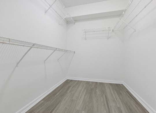 a room with white walls and wood floors and a white closet at Pembroke Pines Landings, Pembroke Pines, Florida