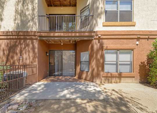A building with a balcony and a gate.