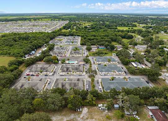 an aerial view of an empty parking lot in a city at The Groves at Wimauma Apartments , Wimauma, FL