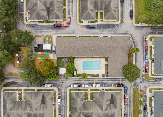 a birds eye view of a neighborhood with houses and a pool at The Groves at Wimauma Apartments , Wimauma, 33598