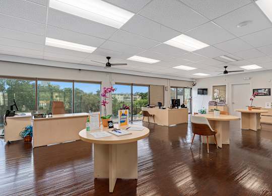 an office space with desks and chairs and a large window at Cypress Grove, Florida