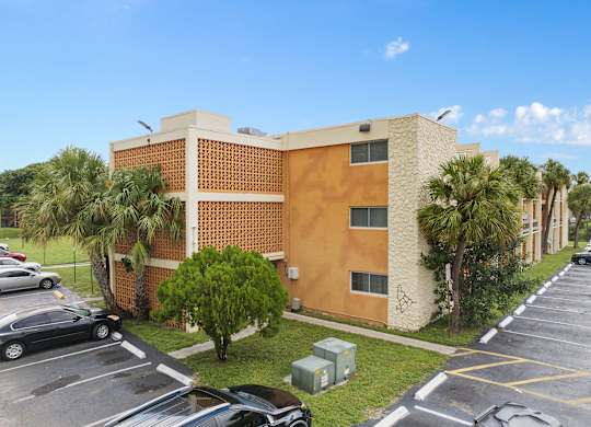 a rendering of a building with a blue sky above it at Cypress Grove, Lauderhill, 33313