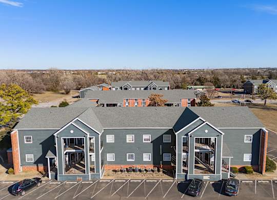a view of a building from above with cars parked in a parking lot at Emerald Greens, Norman Oklahoma