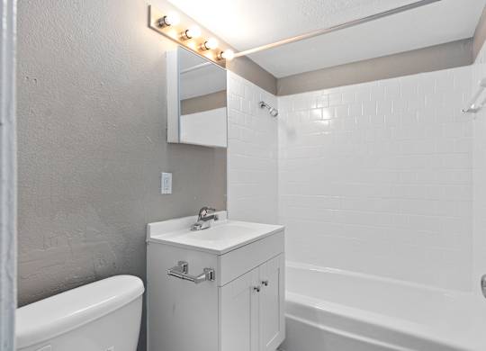a bathroom with a sink and a tub and a mirror at Emerald Greens, Norman Oklahoma