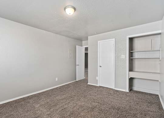 an empty room with carpet and a closet at Emerald Greens, Norman Oklahoma