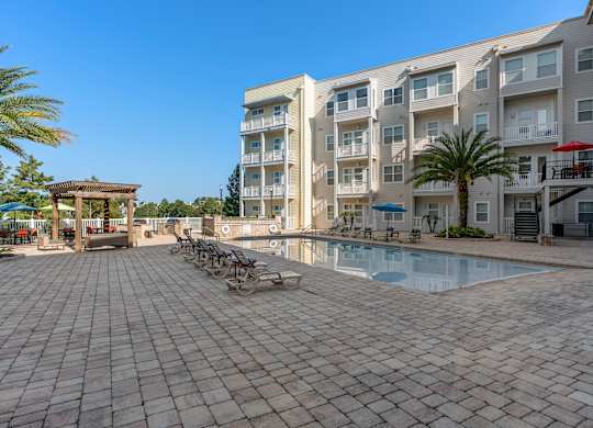 a large swimming pool in front of an apartment building at Lake Lofts at Deerwood, Jacksonville, FL, 32216