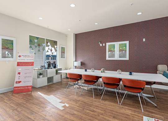a conference room with a long table and chairs at Lake Lofts at Deerwood, Jacksonville, FL, 32216