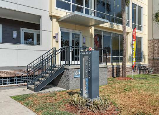 the front of a building with a sign in front of itat Lake Lofts at Deerwood, Jacksonville, FL