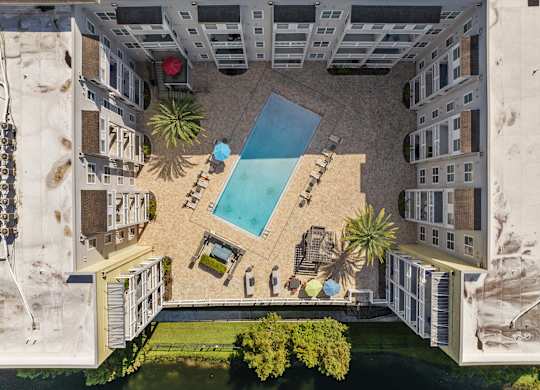 an aerial view of an apartment building with a swimming poolat Lake Lofts at Deerwood, Florida, 32216