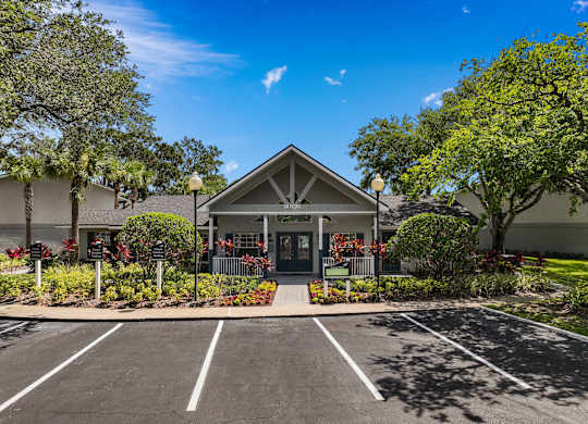 the front of a building with a parking lot and trees at Oak Reserve at Winter Park, Winter Park