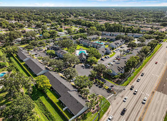 an aerial view of a neighborhood with cars parked in a parking lot at Oak Reserve at Winter Park, Winter Park, FL