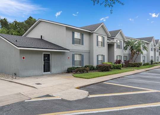 a white house with a street and a parking lot at Oak Reserve at Winter Park, Winter Park, 32792