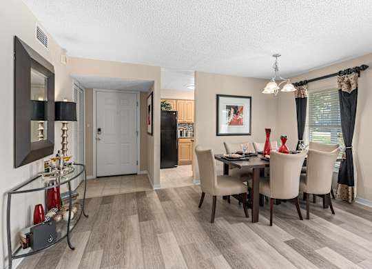 the living room and dining room of a home with a table and chairs at Oak Reserve at Winter Park, Florida