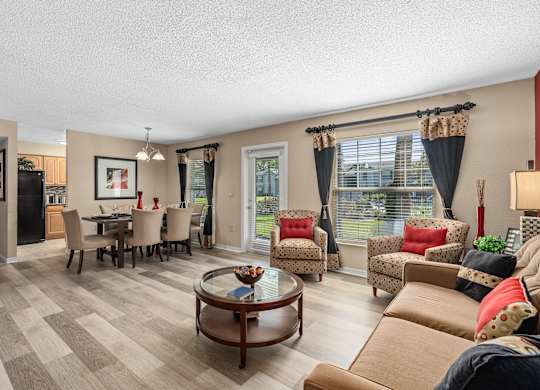 a living room with couches and chairs and a dining room table at Oak Reserve at Winter Park, Florida, 32792