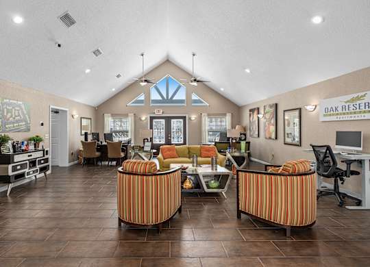 the lobby of a clubhouse with couches and chairs at Oak Reserve at Winter Park, Winter Park