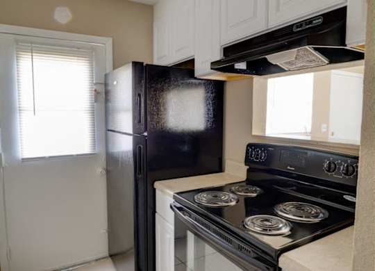 Updated Kitchen With Black Appliances at Hibiscus Place Apartments, Orlando, 32808