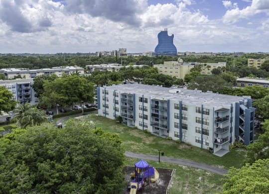 an aerial view of a building with a large blue object in the background  at Club at Emerald Waters, Hollywood, FL