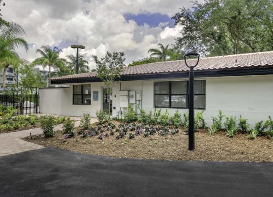 a white house with a garden in front of it  at Club at Emerald Waters, Florida