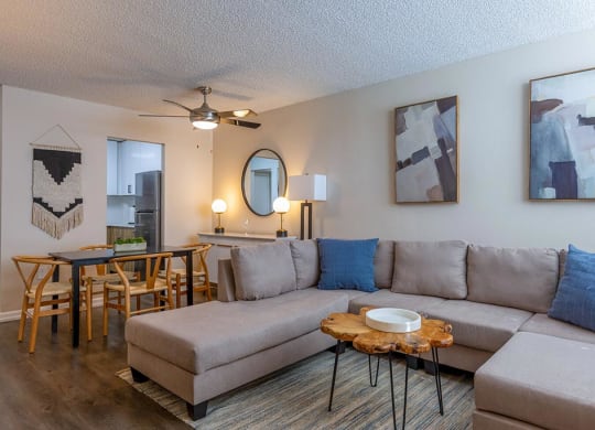 a living room with a couch and a table with chairs  at Club at Emerald Waters, Hollywood, Florida