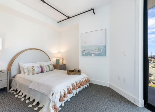 Bedroom with low platform bed and boho decor.