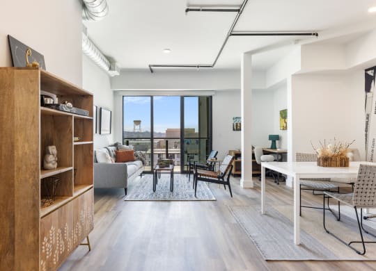 Large kitchen facing a balcony with a lot of natural lighting. The room is decorated with mid century furniture.