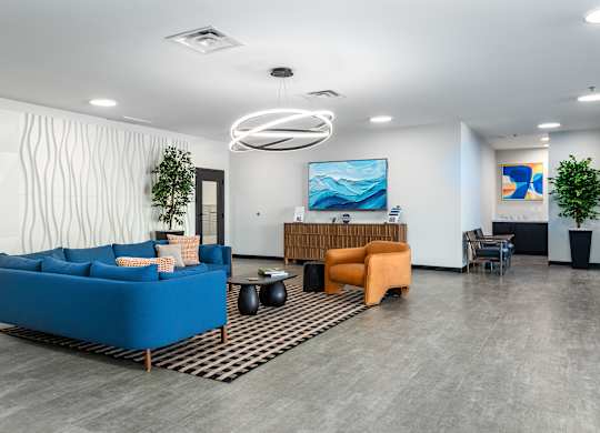 A modern living room with a blue sofa and a wooden table.