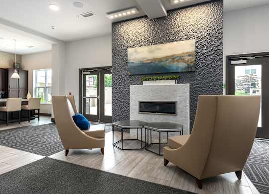 A modern living room with a fireplace and two chairs.